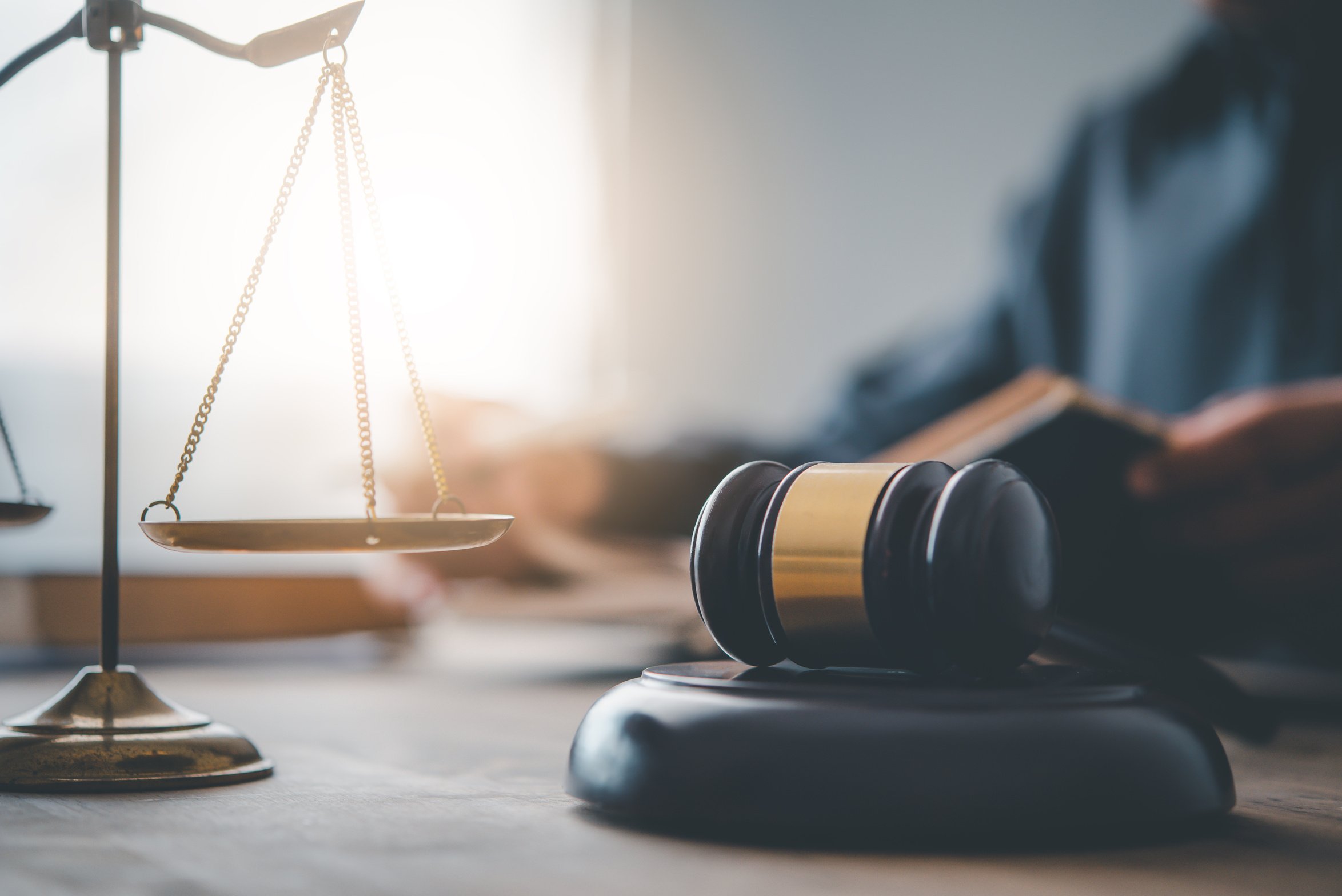 Wooden Gavel with Law Scale on the Table 